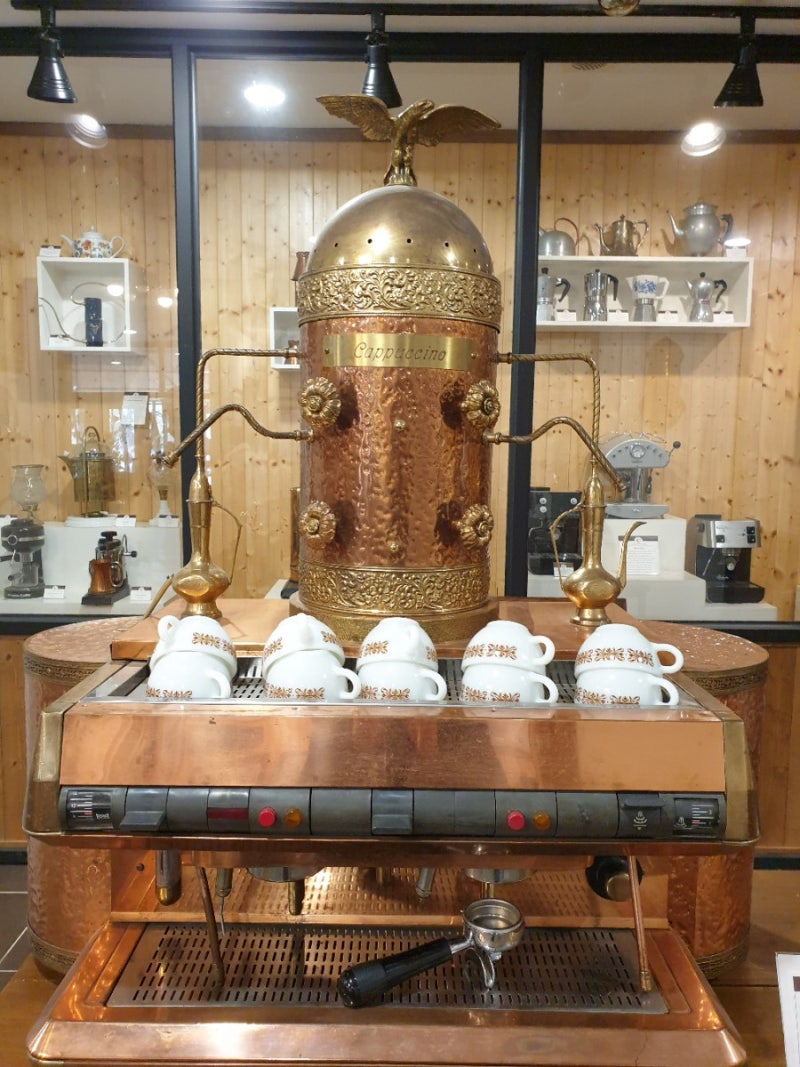 Antique copper cappuccino machine with espresso cups