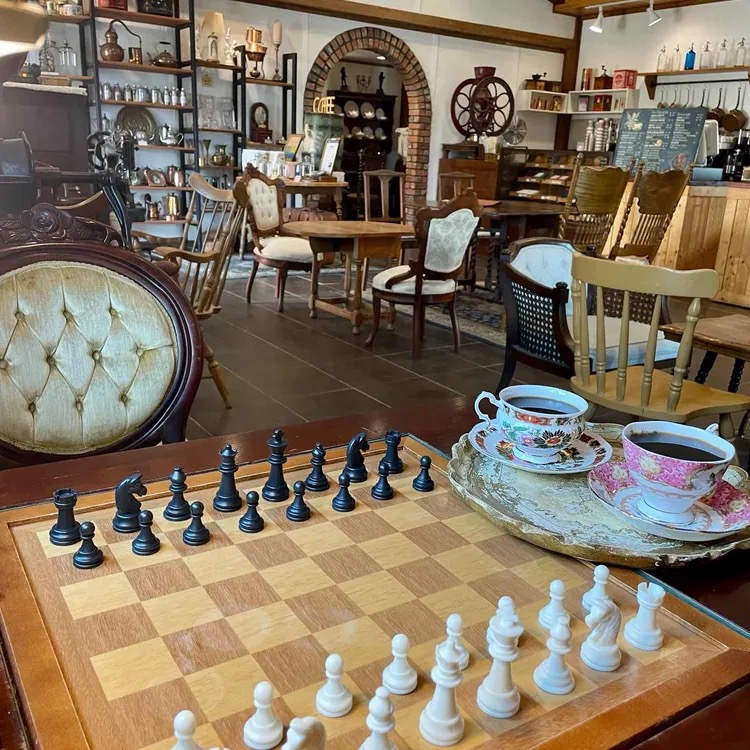 Antique café room with chessboard and teacups