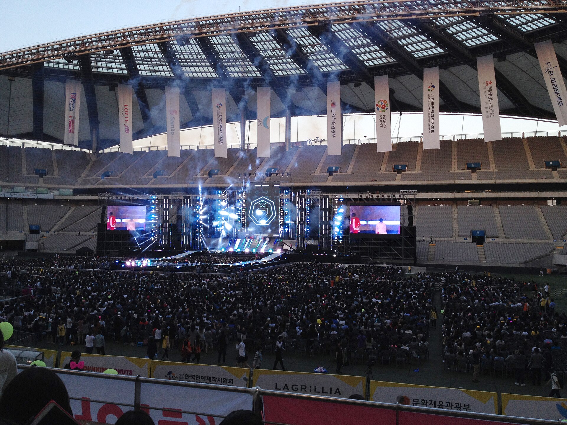 K-pop group performing on an outdoor stage